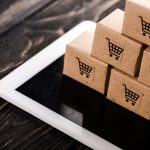 selective focus of small carton boxes on digital tablet, e-commerce concept selective focus of small carton boxes on digital tablet, e-commerce concept